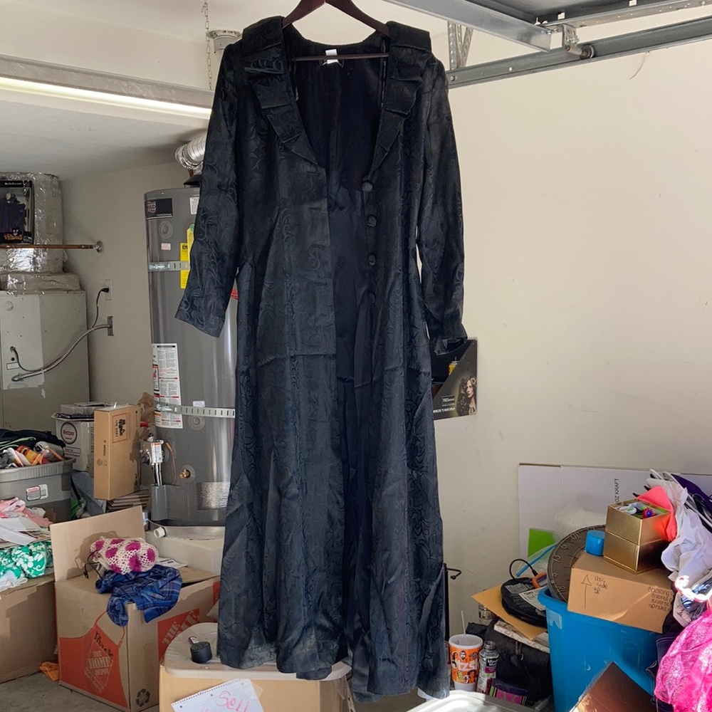 A black long Jessica McClintock jacket a beautiful formal jacket
